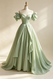 Light green evening gown with bow straps on a mannequin against a neutral background