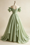Green evening gown on a mannequin against a beige background