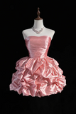 Pink dress on a mannequin with a black background