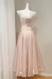 Blush pink dress on a mannequin against a neutral background