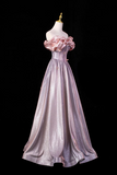 Pink evening gown on a mannequin against a black background