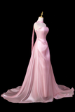 Pink evening gown on a mannequin against a black background