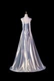 Silver evening gown on a mannequin against a black background