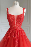 Red evening gown with floral lace details on a mannequin against a neutral background