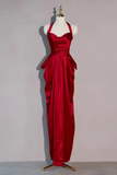 Red evening gown on a mannequin against a plain background