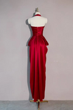 Red evening gown on a mannequin against a plain background