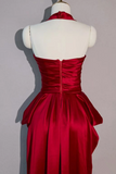 Red evening gown on a mannequin against a gray background