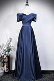 Navy blue evening gown on a mannequin against a white background