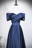 Navy blue evening gown on a mannequin against a white background