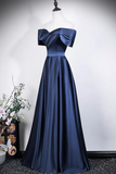 Navy blue evening gown on a mannequin against a white background
