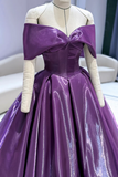 Purple evening gown on a mannequin with white gloves against a neutral background