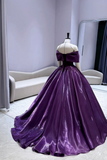 Purple evening gown on a mannequin against a neutral background