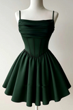 A dark forest green spaghetti-strap mini dress with a ruched bodice and flared skirt, displayed on a white mannequin against a light gray background.