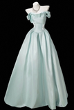 A light mint green off-the-shoulder ball gown displayed on a white mannequin torso against a solid black background.