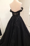 A black off-the-shoulder ball gown with intricate lace and bead embroidery, displayed on a mannequin in an indoor setting.