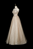 A champagne-colored A-line ball gown with a halter neckline and intricate beadwork on the bodice, displayed on a mannequin against a solid black background.
