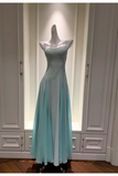 A sleeveless, floor-length gown in a pale mint or light aqua color displayed on a mannequin inside a white built-in wardrobe or closet. The dress has a fitted bodice and a flowing skirt with a slight sheen.