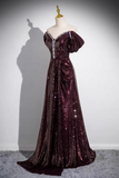 A floor-length off-the-shoulder evening gown covered in deep burgundy sequins, displayed on a mannequin against a light gray wall with a strong shadow.