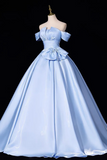 A light blue off-the-shoulder ball gown displayed on a mannequin against a solid black background.