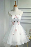 White sleeveless tulle dress with pink floral embroidery and green leaves, displayed on a mannequin torso.