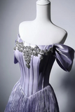 Lavender evening gown with embellishments on a mannequin against a gray background