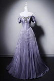 Elegant purple evening gown on a mannequin against a gray background
