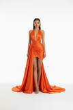 Orange satin halter mermaid prom dress with deep V-neckline and dramatic train